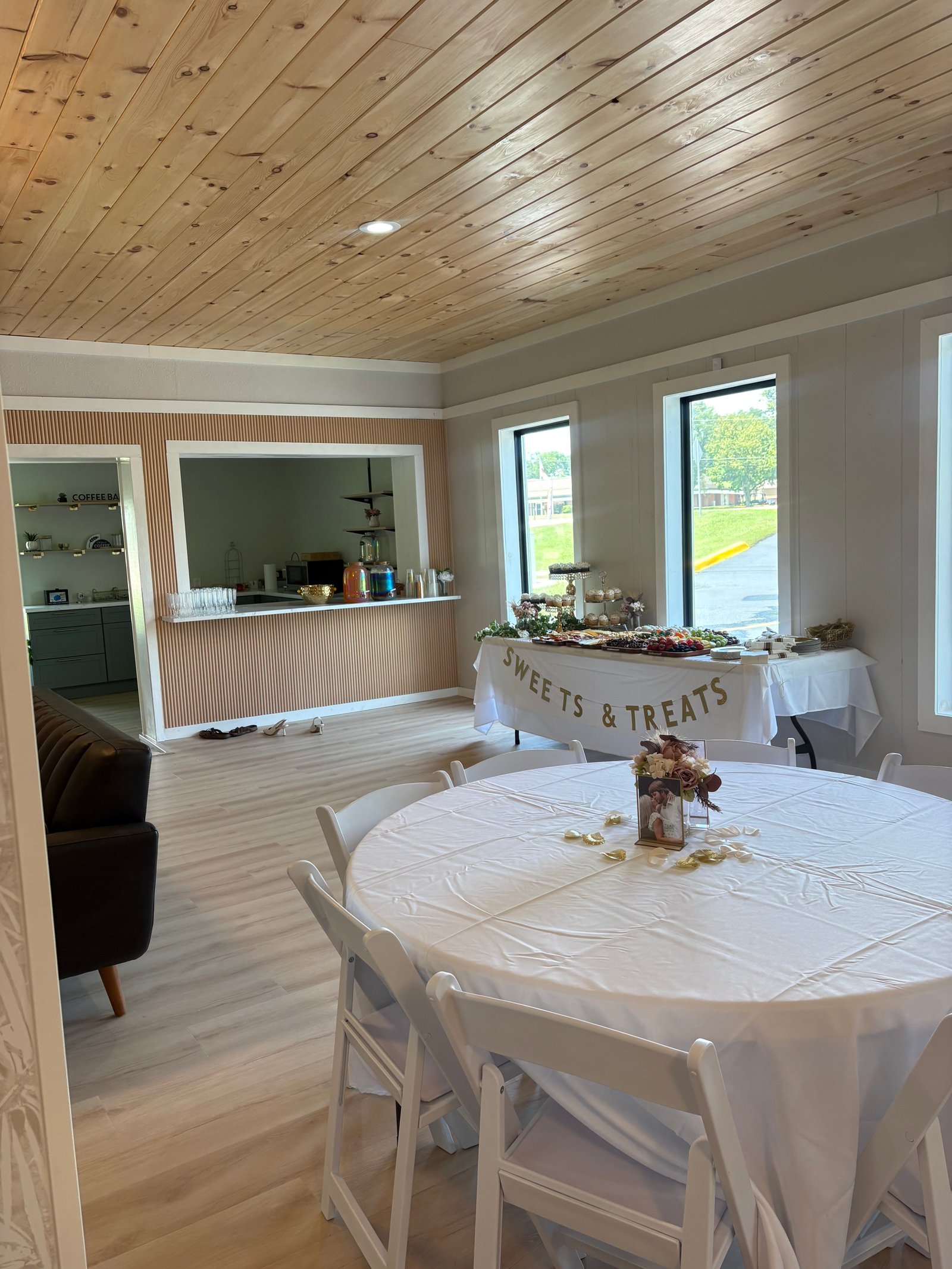 Decorated event room at MeetUps Event Center with round guest seating, a sweets and treats table, and a bright setup for family celebrations