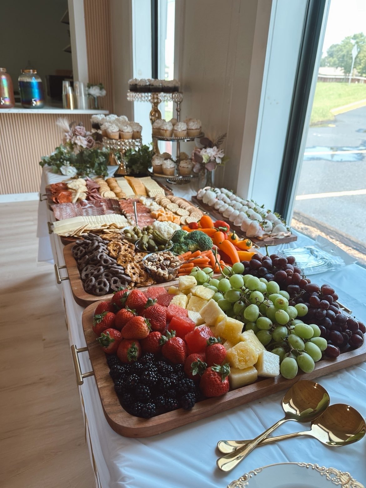 Prepared food display at MeetUps Event Center with fresh fruit, charcuterie, and desserts for a warm and welcoming gathering